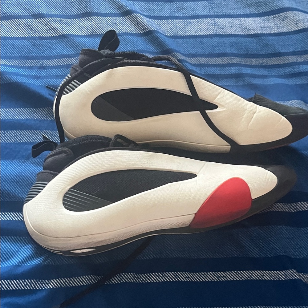 Stylish Black and White Sneakers with Red Accent